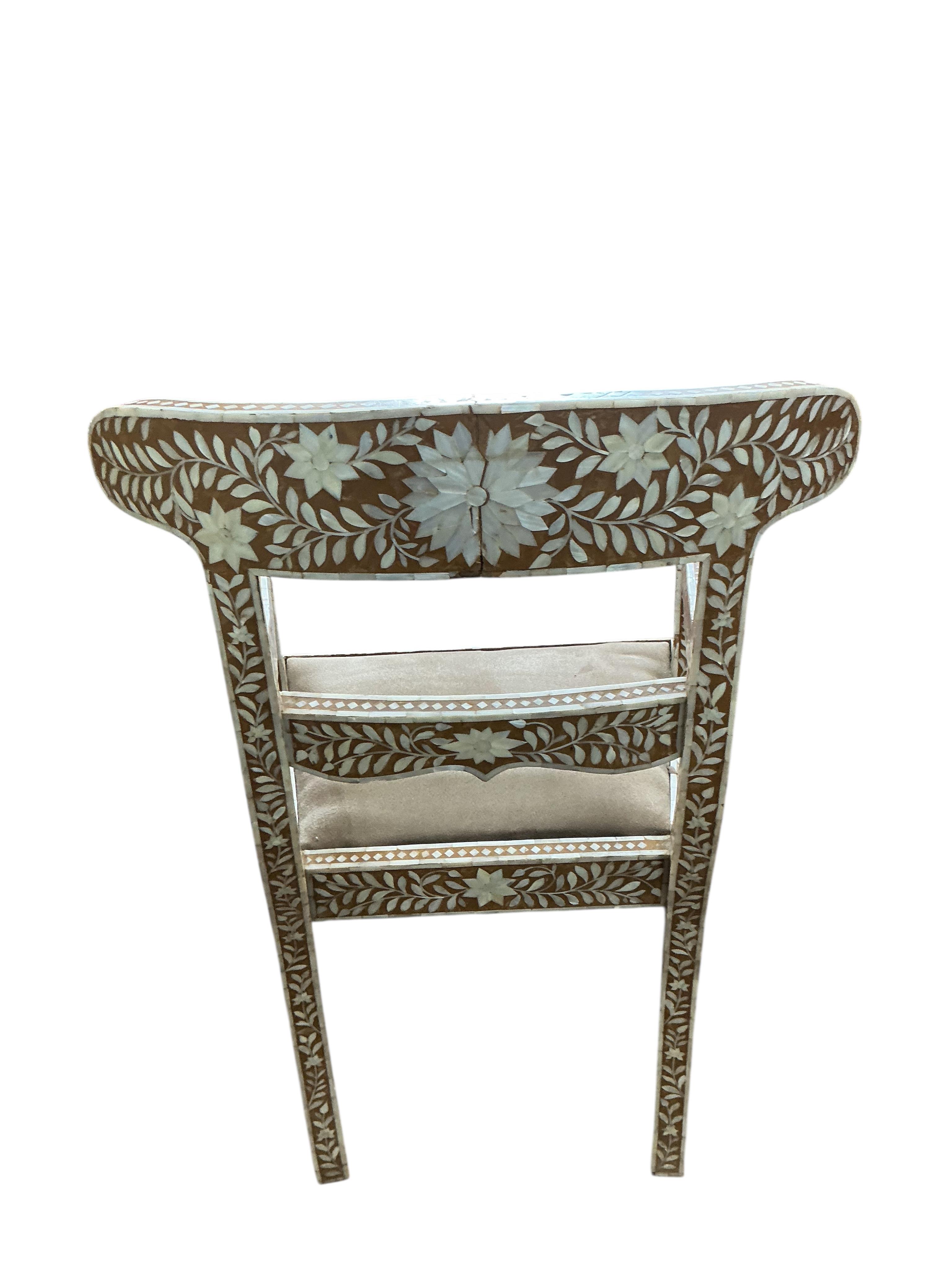 A 19th century Anglo Indian mother of pearl inlaid elbow chair, width 56cm, depth 44cm, height 90cm